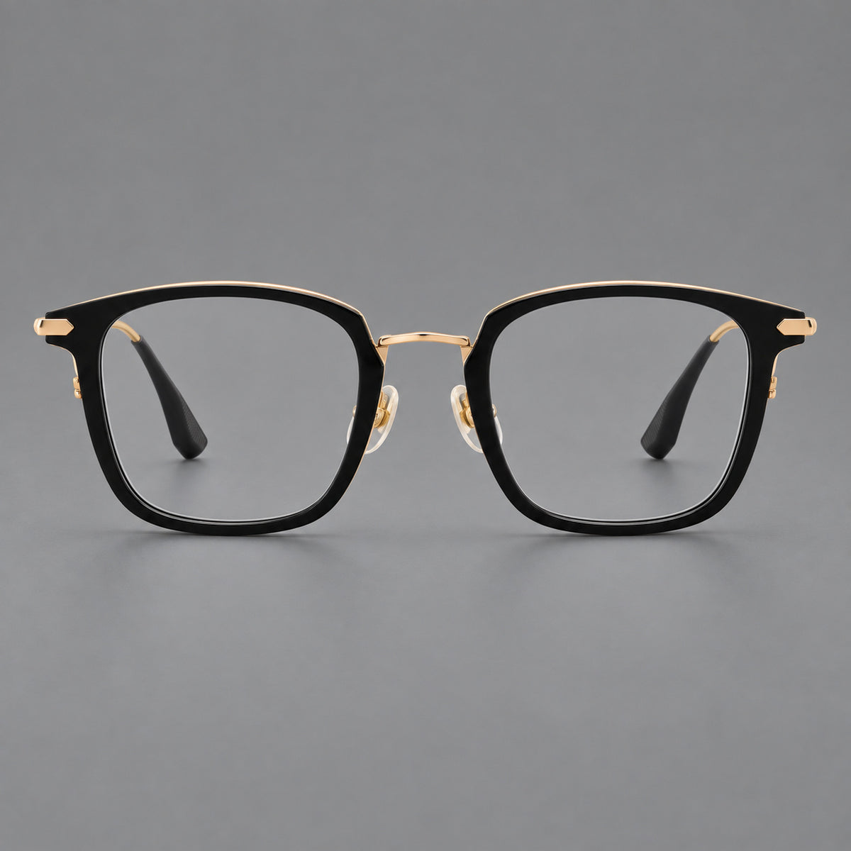 Bold square titanium glasses with a separate bridge and long metal corner accents in Black and Gold, front view