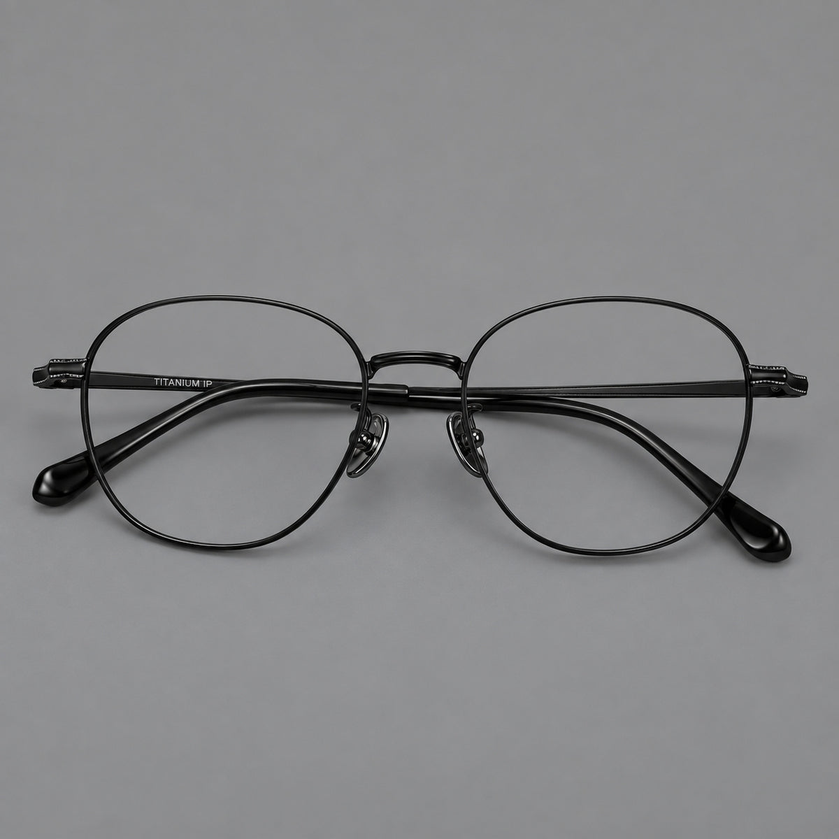 Retro panto titanium glasses with stepped corners and finely engraved temples in Black, front view