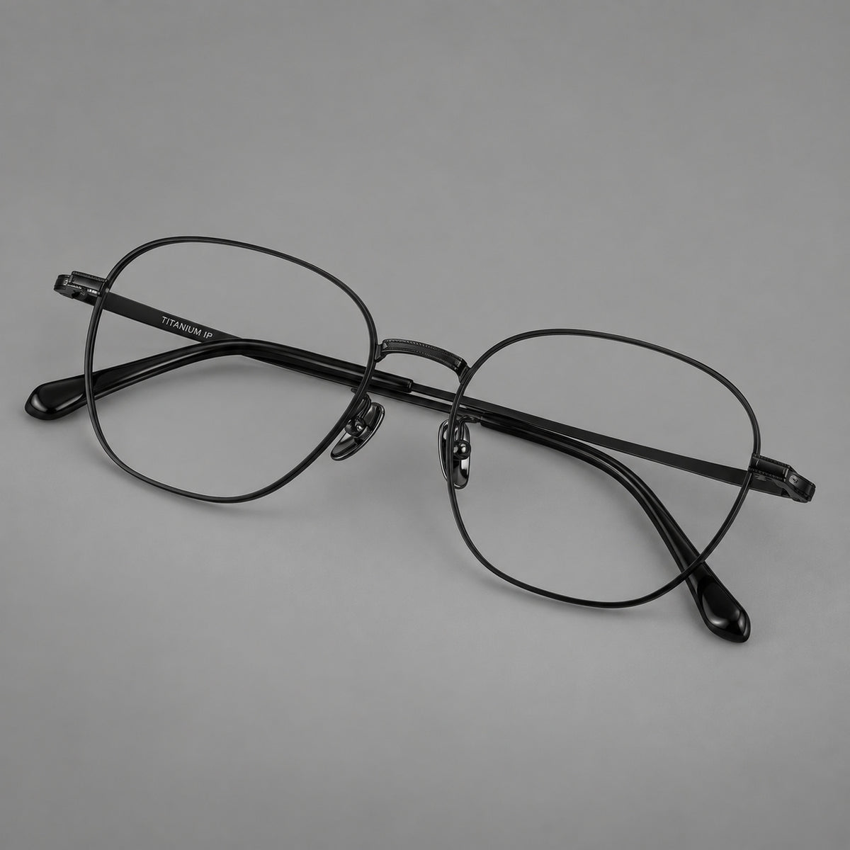 Retro panto titanium glasses with stepped corners and finely engraved temples in Black, three quarter view