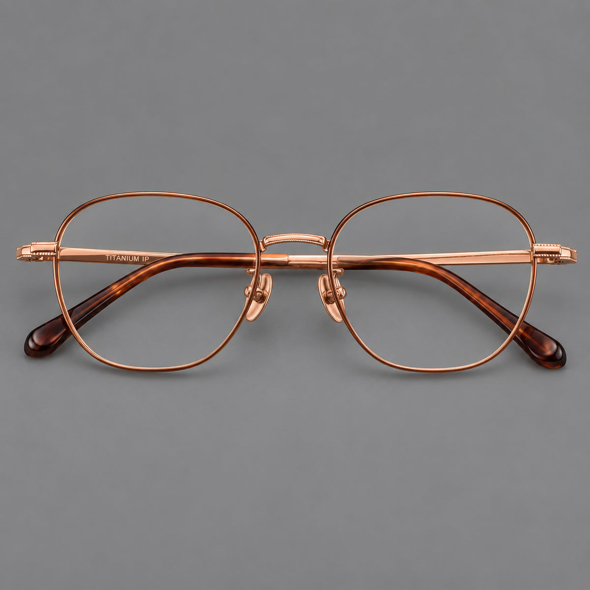 Retro panto titanium glasses with stepped corners and finely engraved temples in Brown and Rose Gold, front view