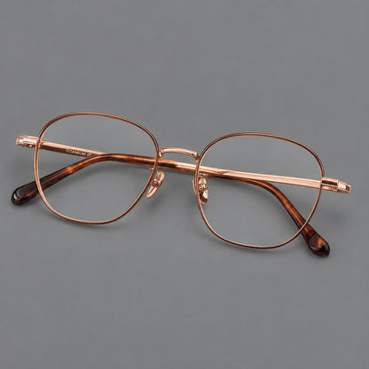 Retro panto titanium glasses with stepped corners and finely engraved temples in Brown and Rose Gold, three quarter view front view