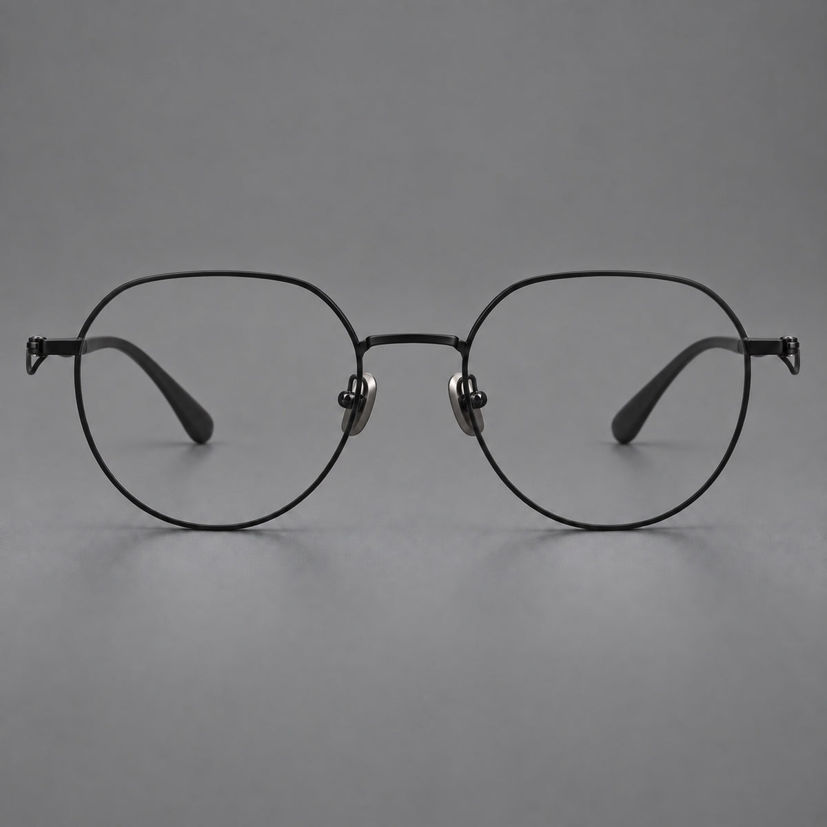 Rounded titanium glasses with a short bridge and distinctive wavy metal temples in Matte Black, front view