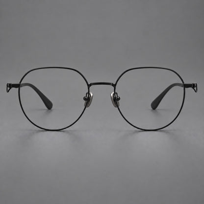 Rounded titanium glasses with a short bridge and distinctive wavy metal temples in Matte Black, front view side view