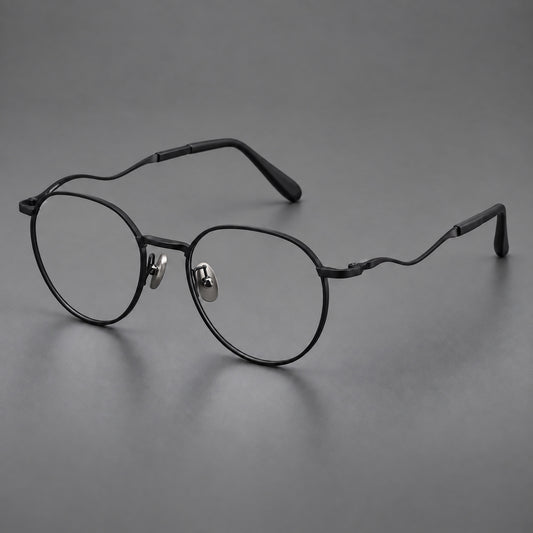 Rounded titanium glasses with a short bridge and distinctive wavy metal temples in Matte Black, three quarter view