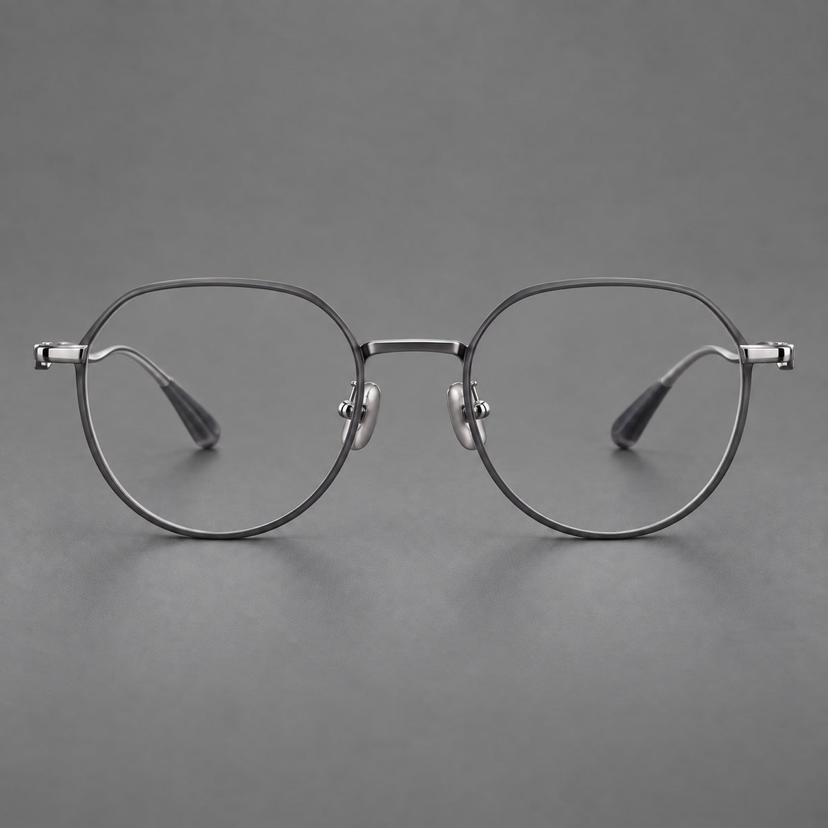 Rounded titanium glasses with a short bridge and distinctive wavy metal temples in Matte Grey and Silver, front view
