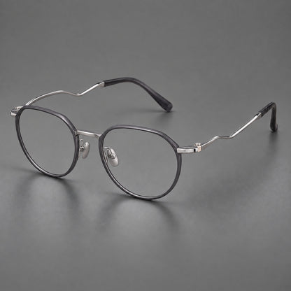 Rounded titanium glasses with a short bridge and distinctive wavy metal temples in Matte Grey and Silver, three quarter view front view
