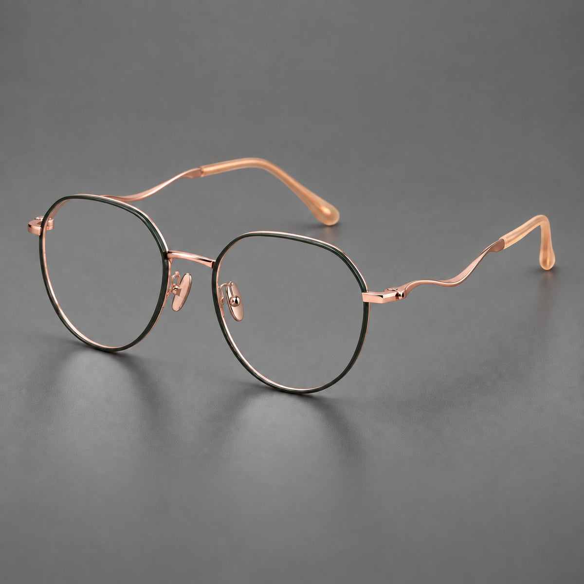 Rounded titanium glasses with a short bridge and distinctive wavy metal temples in Dark Green and Rose Gold, three quarter view