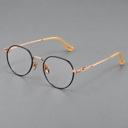 Small panto titanium glasses with an angular bridge and recessed temple details in Black and Rose Gold, three quarter view front view