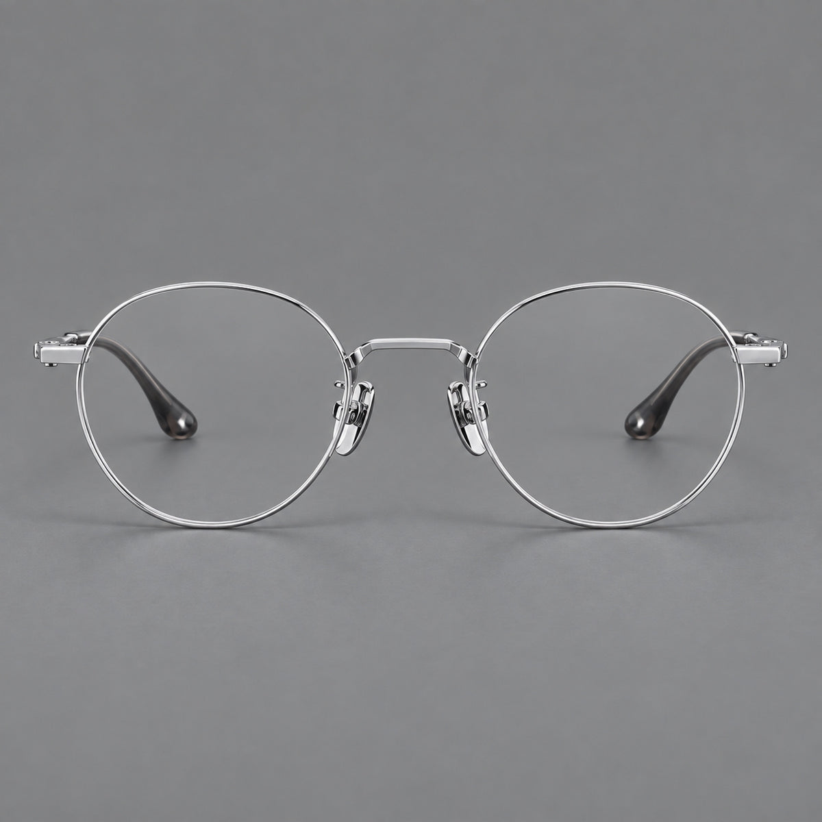 Small panto titanium glasses with an angular bridge and recessed temple details in Silver, front view