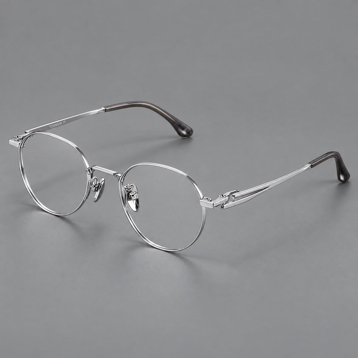 Small panto titanium glasses with an angular bridge and recessed temple details in Silver, three quarter view