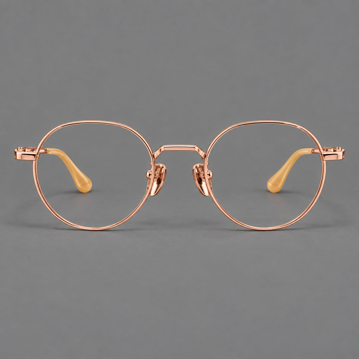 Small panto titanium glasses with an angular bridge and recessed temple details in Rose Gold, front view