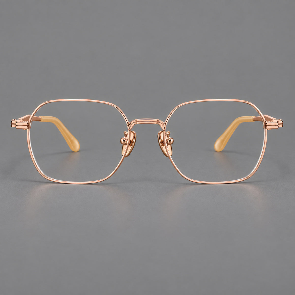 Soft square titanium glasses with an angular bridge and layered corner details in Rose Gold, front view