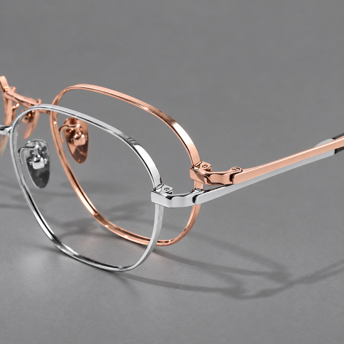 Rounded panto titanium glasses with an angular bridge and broad flat temples, frame details