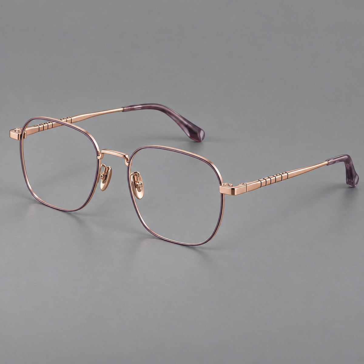 Soft square titanium glasses with a raised bridge and engraved temple bands in Purple and Rose Gold, three quarter view