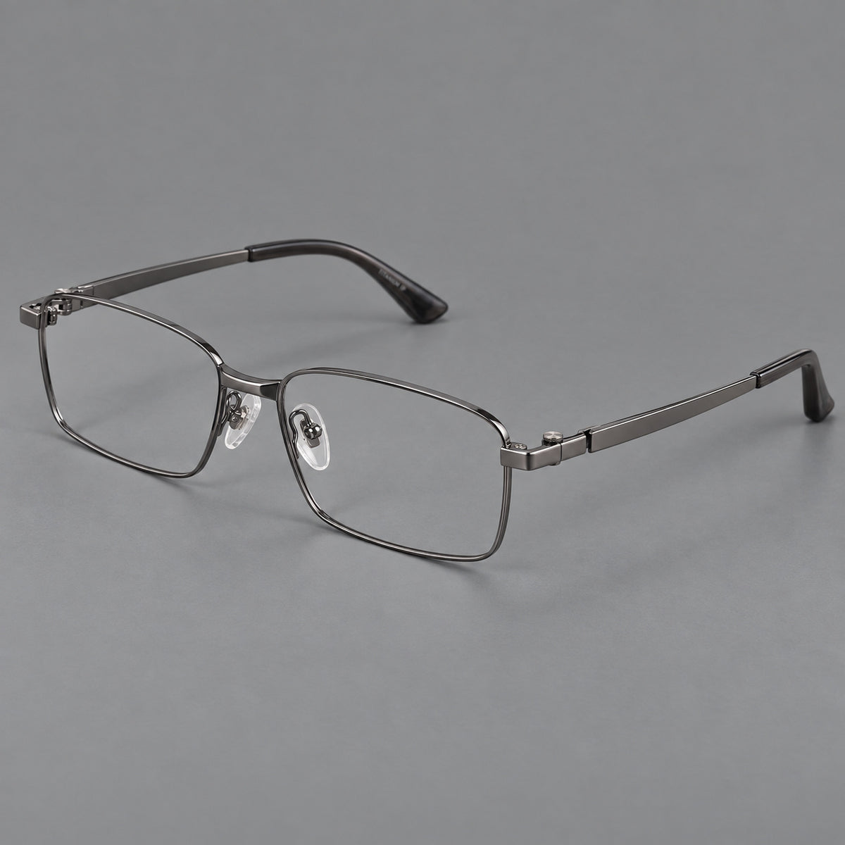 Wide rectangular titanium glasses with a broad bridge and rounded hinge caps in Gunmetal, three quarter view
