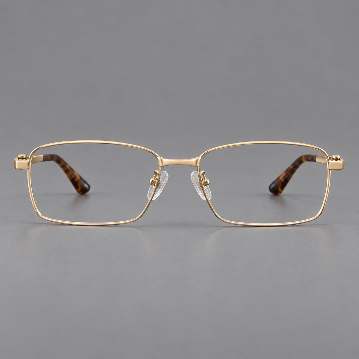 Wide rectangular titanium glasses with a broad bridge and rounded hinge caps in Gold, front view
