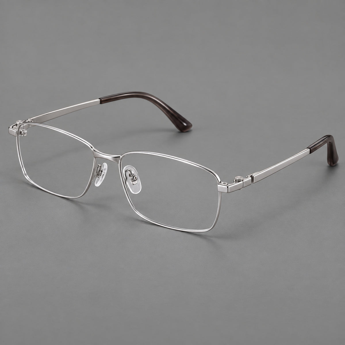 Wide rectangular titanium glasses with a broad bridge and rounded hinge caps in Silver, three quarter view