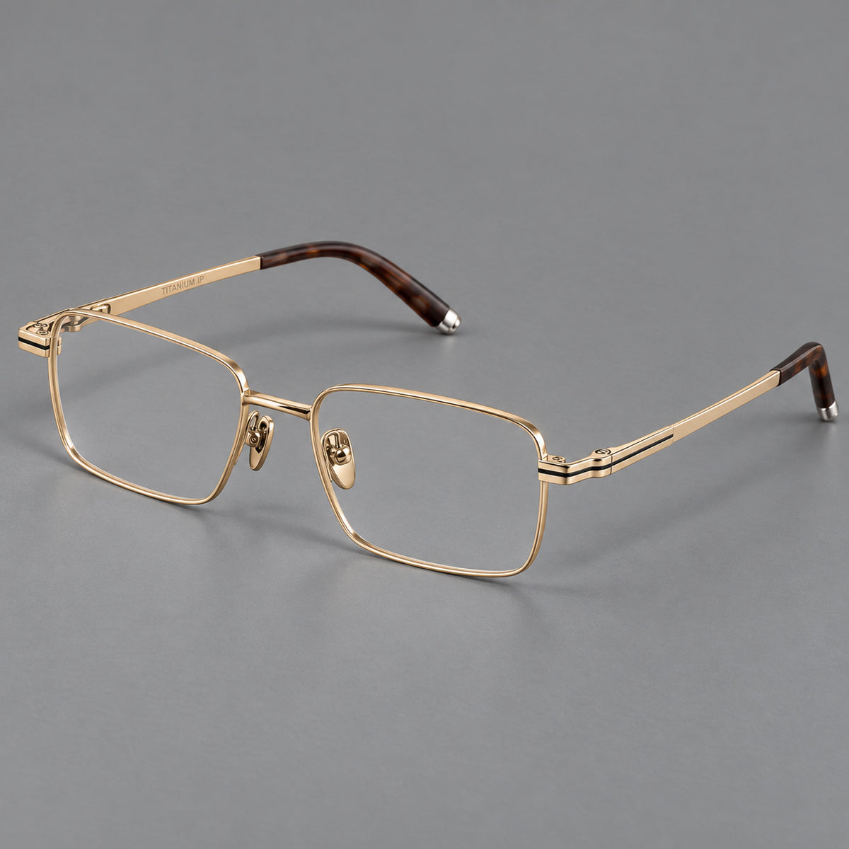Rectangular titanium glasses with inset corner lines and metal capped temple tips in Gold, three quarter view
