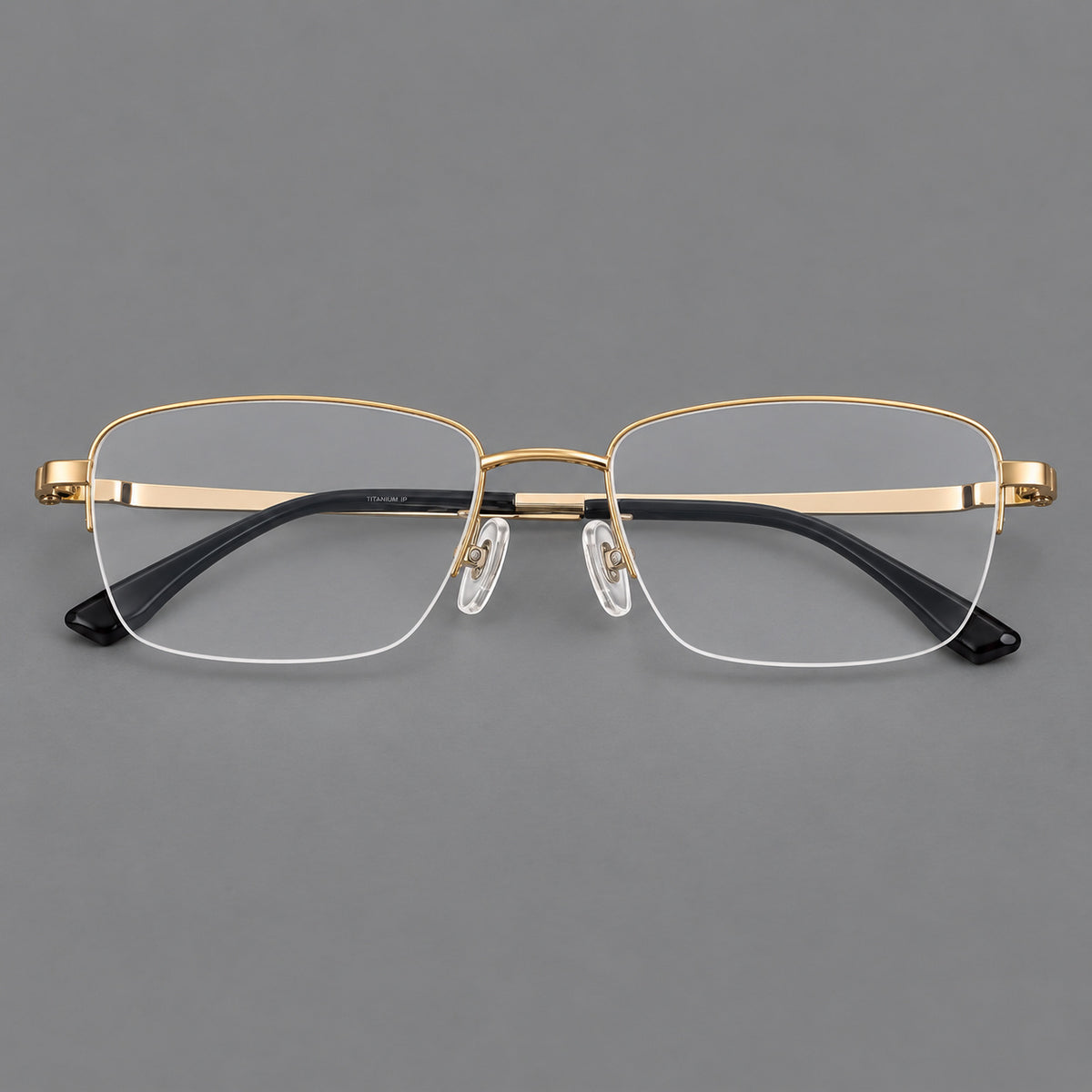 Half frame titanium glasses with rectangular lenses and rounded hinge details in Gold, front view
