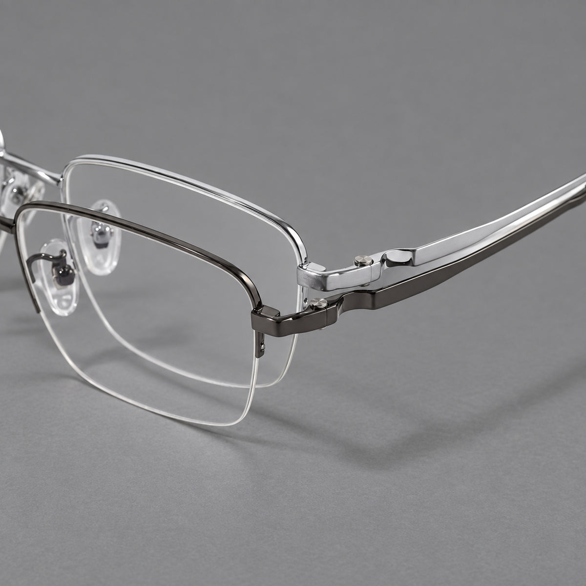Half frame titanium glasses with rectangular lenses and rounded hinge details, frame details