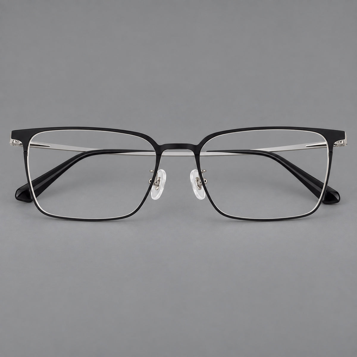 Bold rectangular titanium glasses with strong upper corners and flat metal temples in Black and Silver, front view