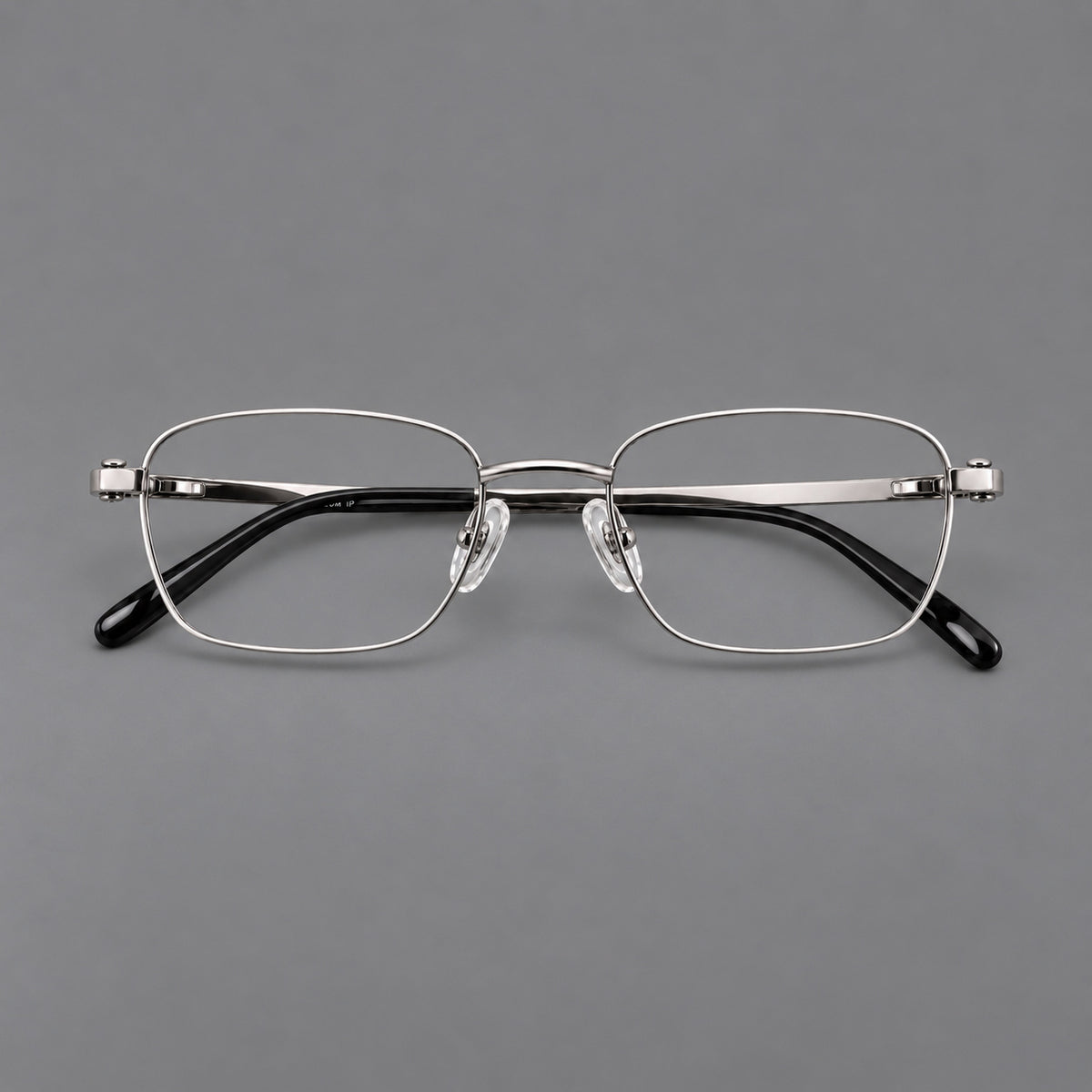 Shallow rectangular titanium glasses with a broad bridge and stepped temple joins in Silver, front view