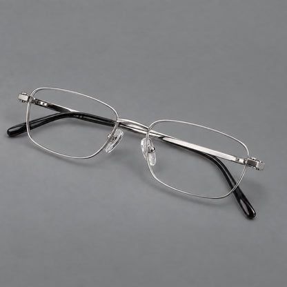 Shallow rectangular titanium glasses with a broad bridge and stepped temple joins in Silver, three quarter view additional product view