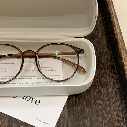 Round Eyeglass Frames with Thin Rims and a Curved Brow, Cool Tea Brown front view